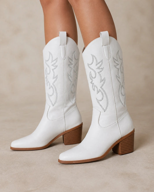 Exact plain white embroidered Western knee-high boots, hero worn view.