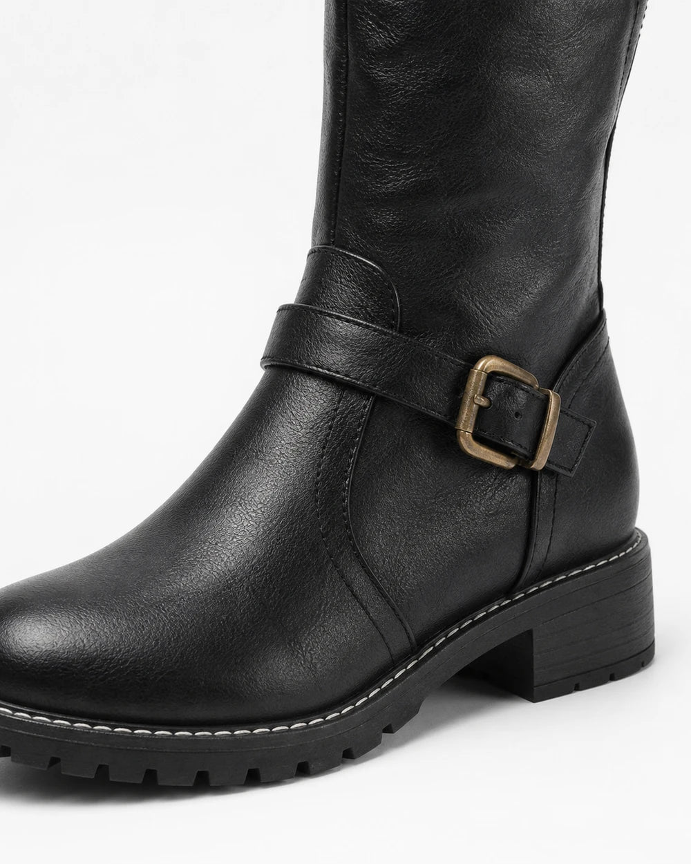 Women's black riding boot, buckle and lug-sole detail.