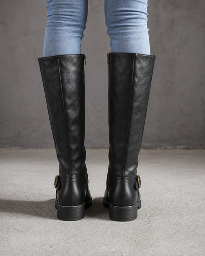 Women's black buckle-strap knee-high riding boots, rear view.