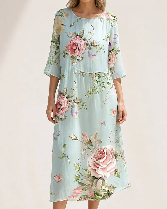 Women's loose floral midi dress in pale blue, front worn view