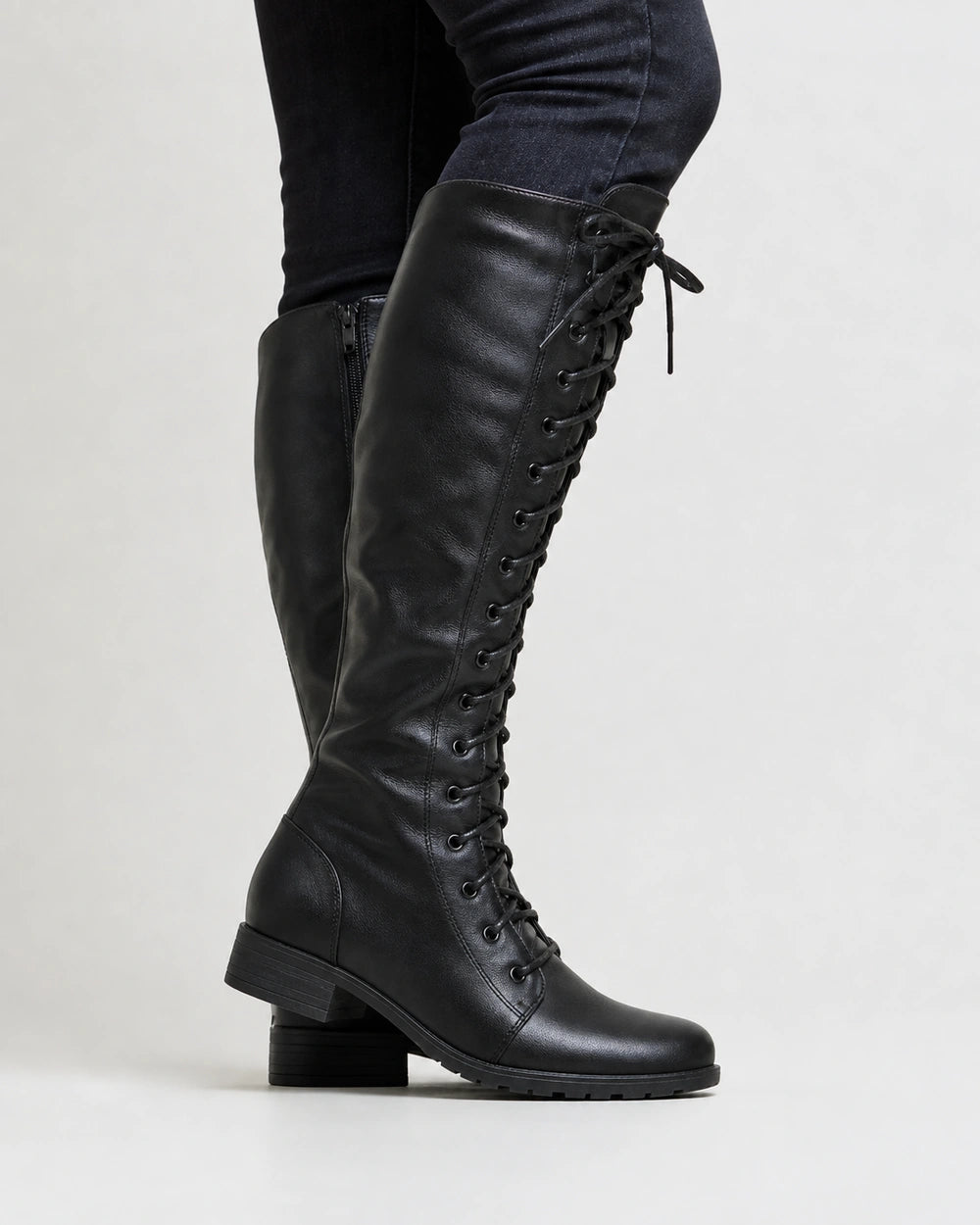 Women's black lace-up knee-high boots, lateral profile.