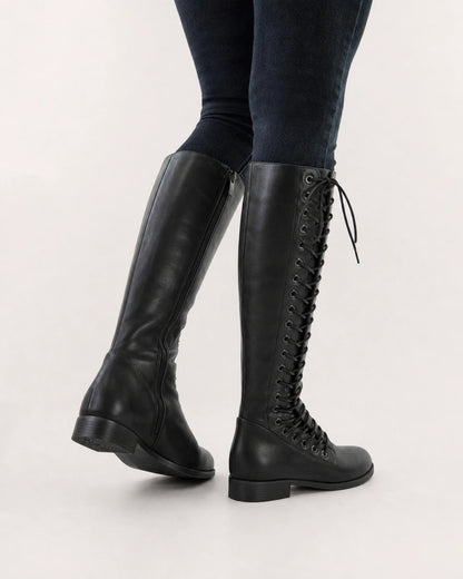 Women's black lace-up knee-high boots, rear three-quarter view.