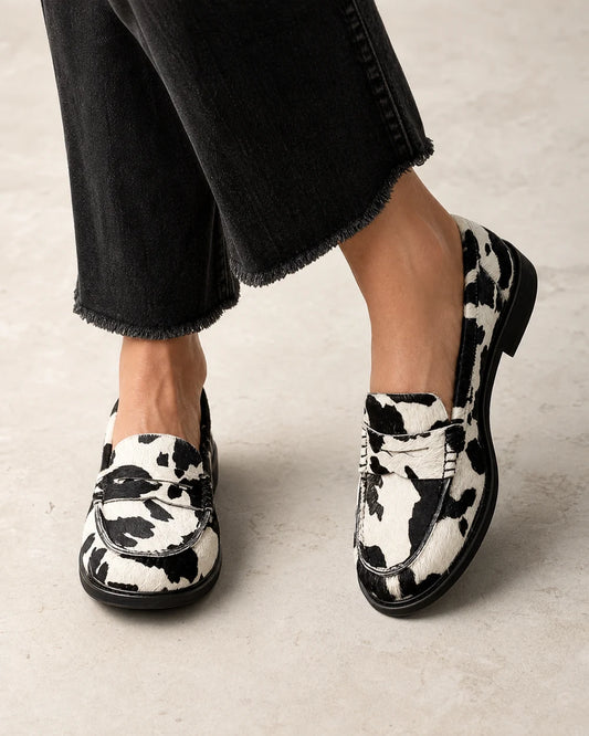 Rosalind | Cow Print Comfort Penny Loafers — loafers-for-women-patterned-slip-on-1-black-white-01-worn-hero.webp