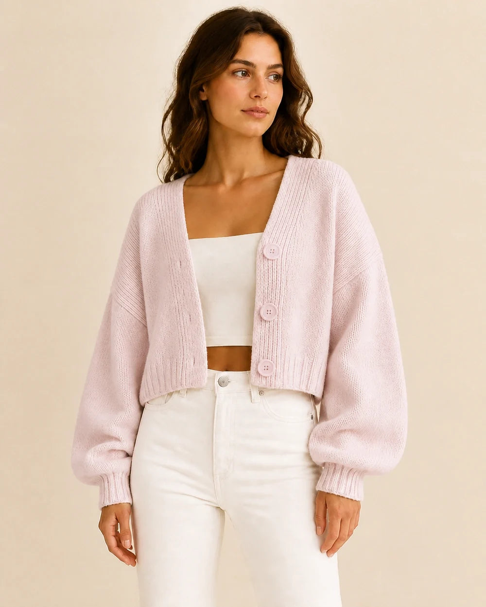 Women's light pink cropped balloon-sleeve cardigan, worn front view