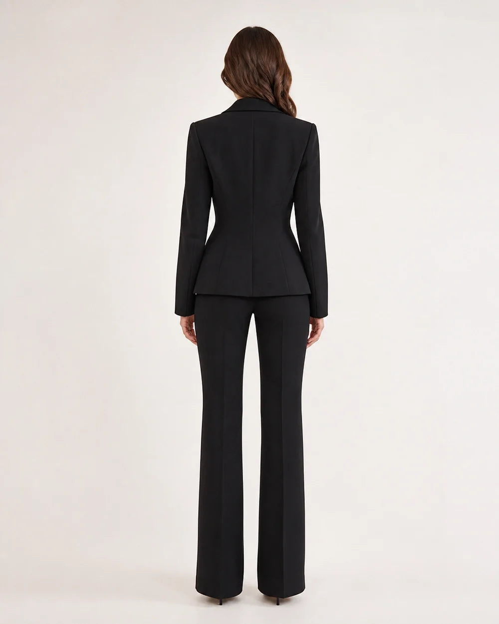 Black fitted blazer and trousers set for women, back view