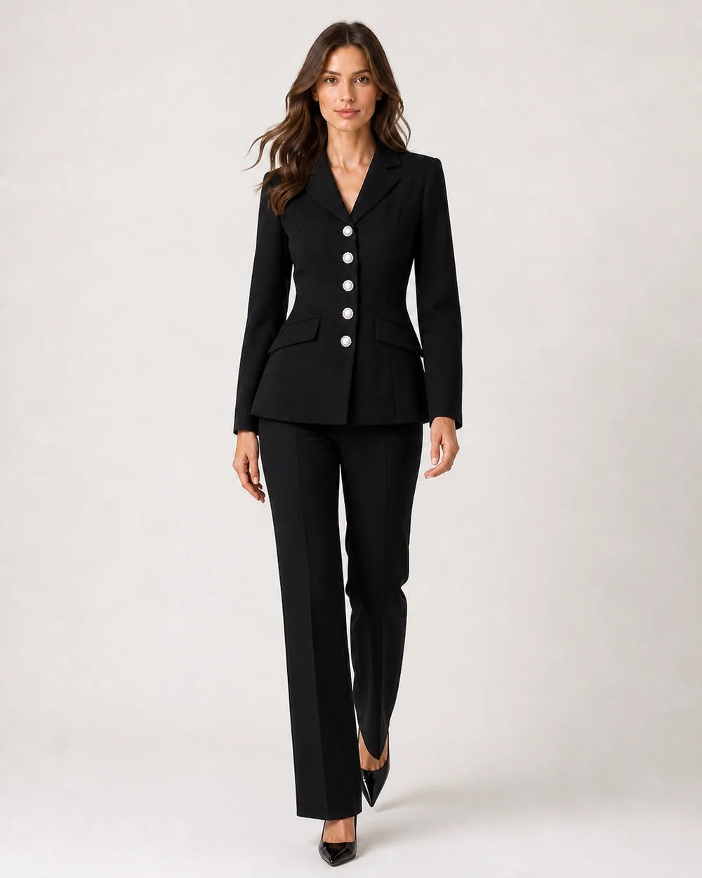 Black fitted five-button suit for women, walking view