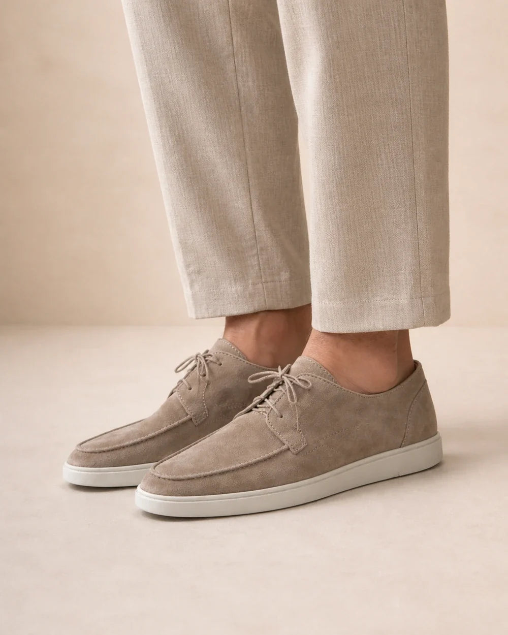 Lateral worn profile of beige lace-up moccasins.