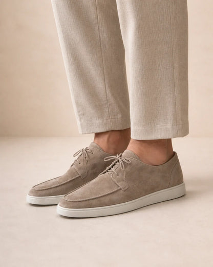 Lateral worn profile of beige lace-up moccasins.
