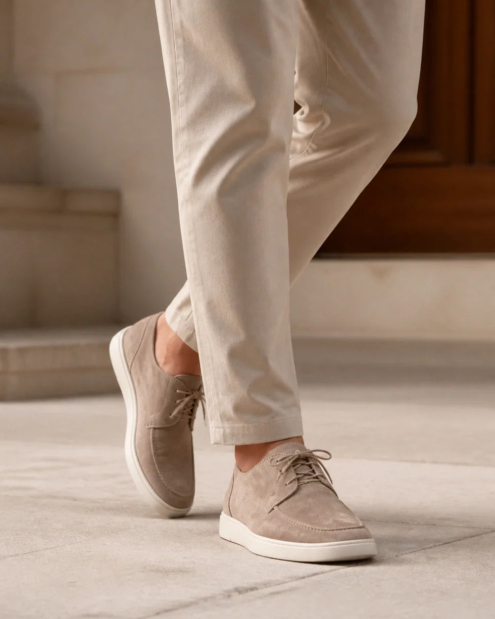 Men wearing beige lace-up moccasins in motion.