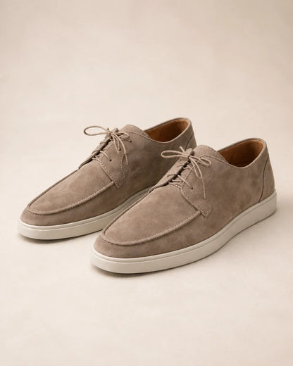 Pair of beige lace-up suede-effect moccasins on a neutral background.