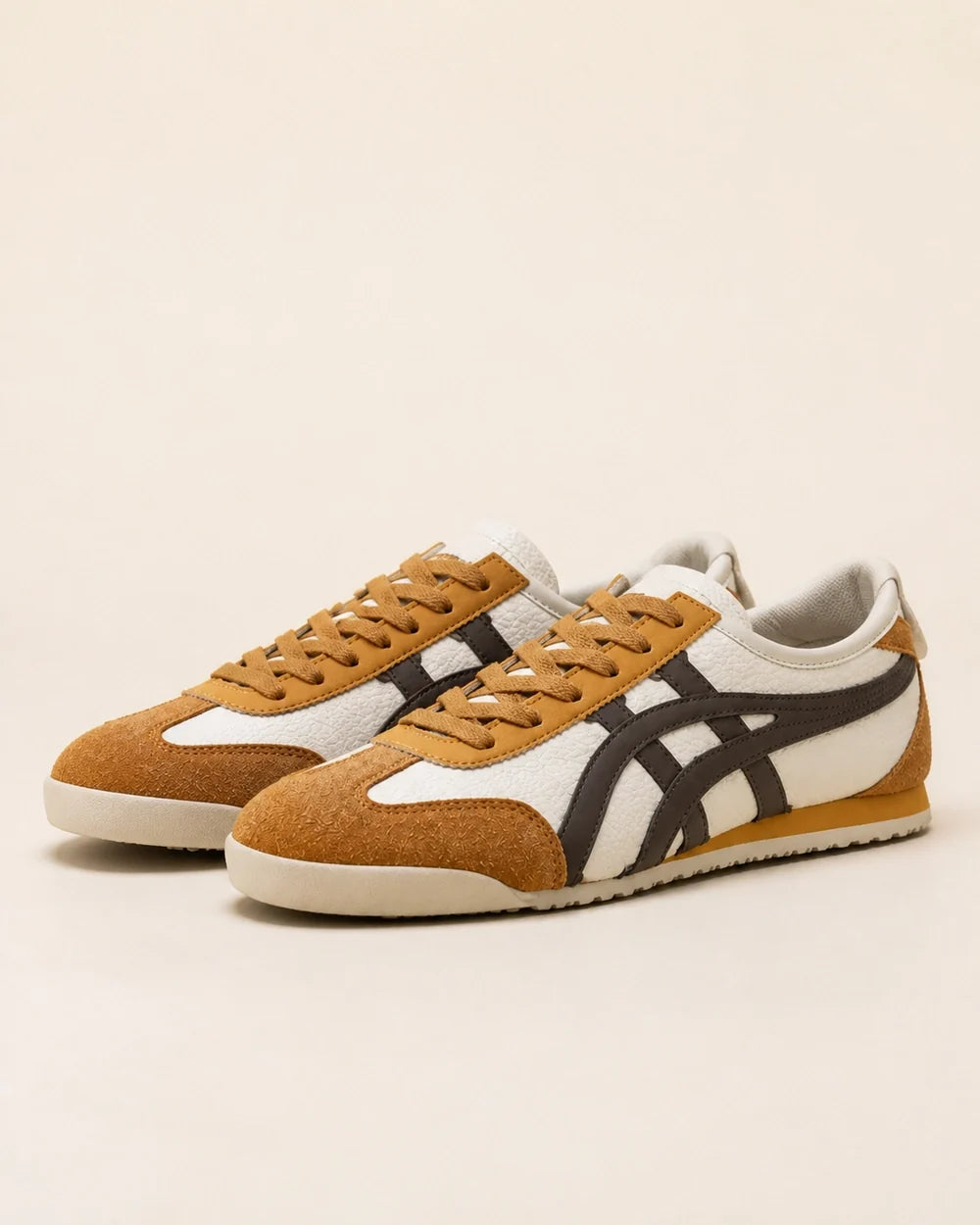 Pair of brown-yellow retro panel sneakers on a neutral background.
