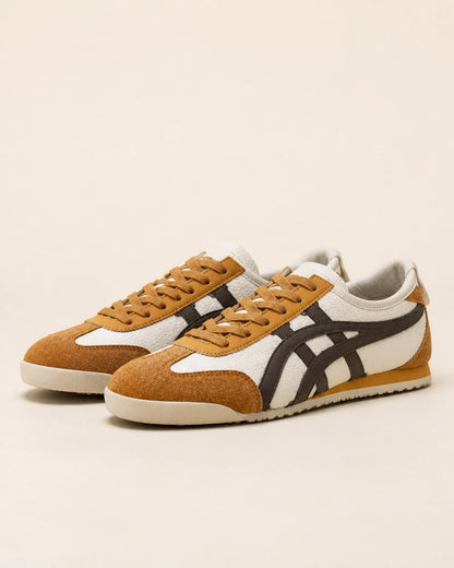Pair of brown-yellow retro panel sneakers on a neutral background.