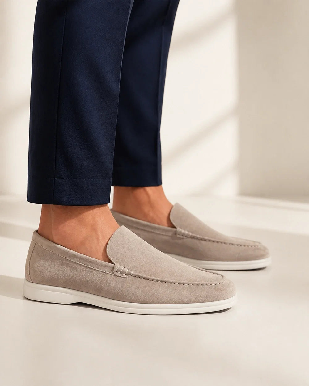 Men wearing beige slip-on loafers, lateral profile.