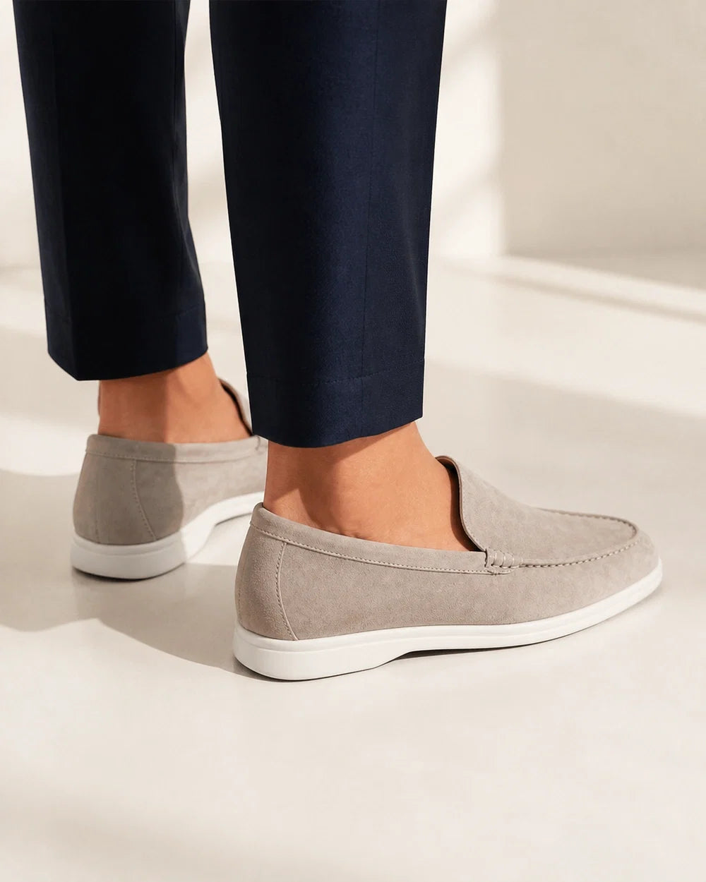 Rear and heel view of beige suede-effect slip-on loafers.