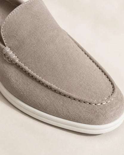 Close detail of beige loafer apron stitching and contrast sole.