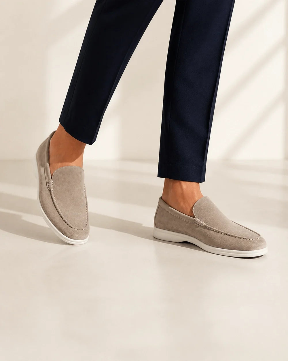 Men wearing beige slip-on loafers in motion.