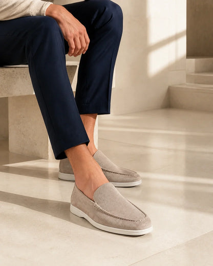 Seated styling view of men's beige slip-on loafers.