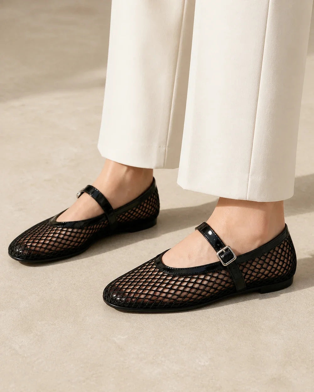 Women’s black mesh Mary Jane ballet flats, lateral profile and buckle view.