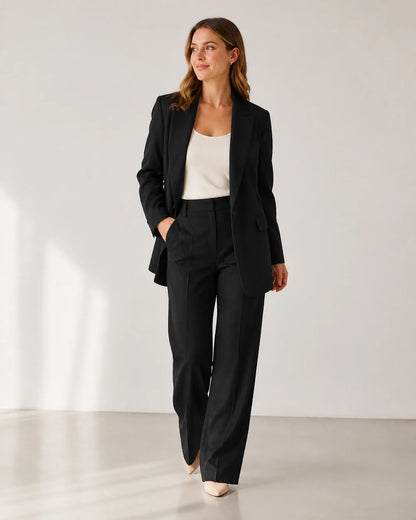 Black relaxed blazer and wide-leg trousers set for women, walking view