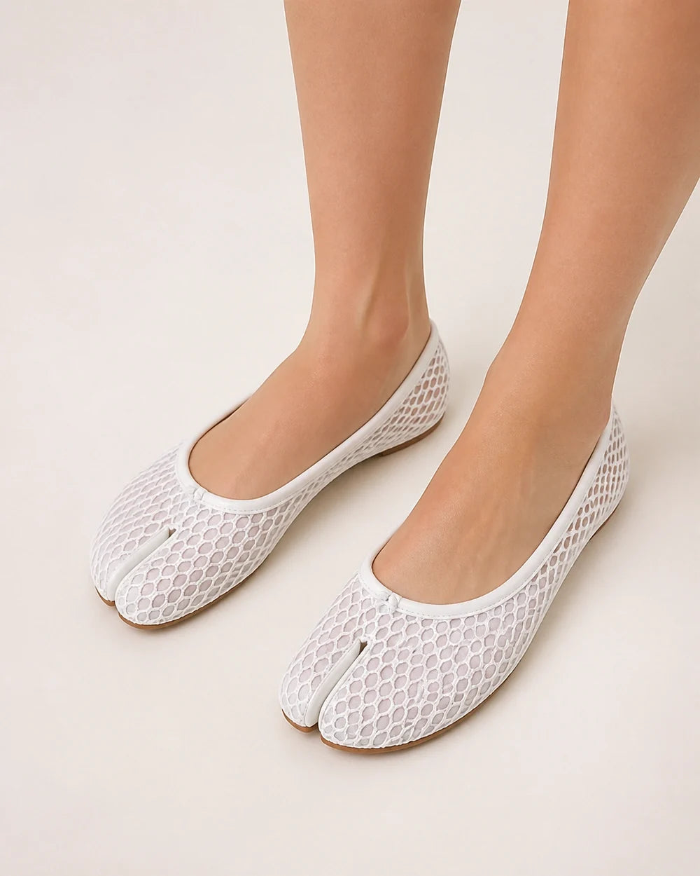 Women's white mesh tabi ballet flats, elevated top view.