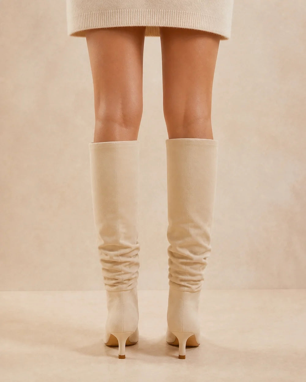 Beige slouchy knee-high boots, rear view