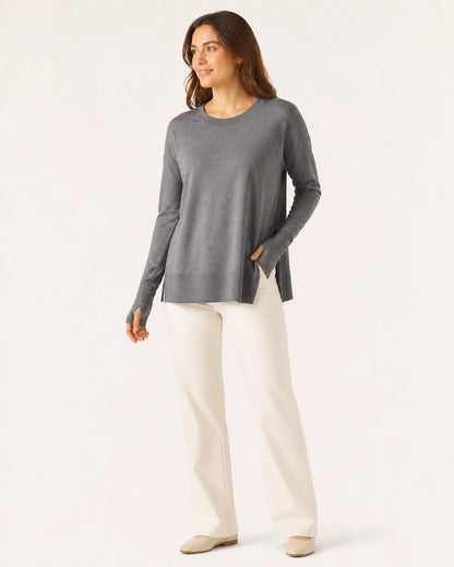 Women's charcoal dolman thumbhole pullover styled with ivory trousers