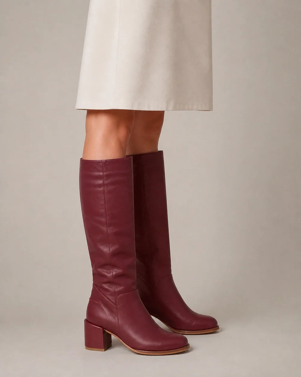 Burgundy leather knee-high boots, profile view