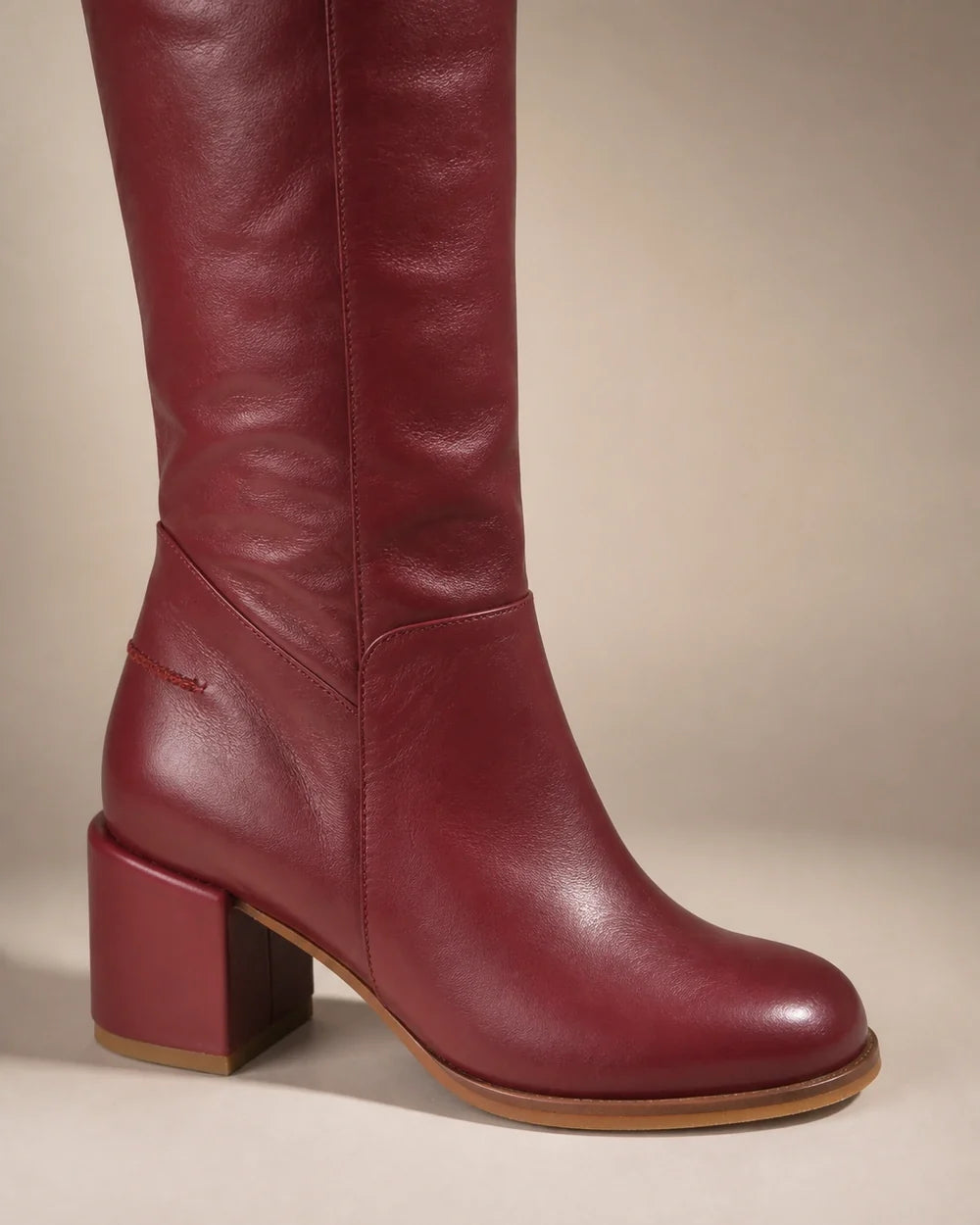 Burgundy leather knee-high boots, detail view