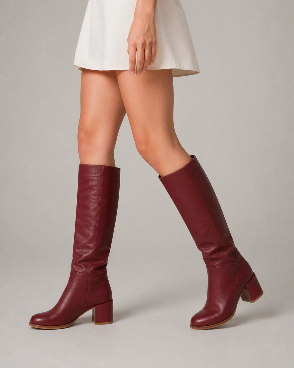 Burgundy leather knee-high boots, movement view