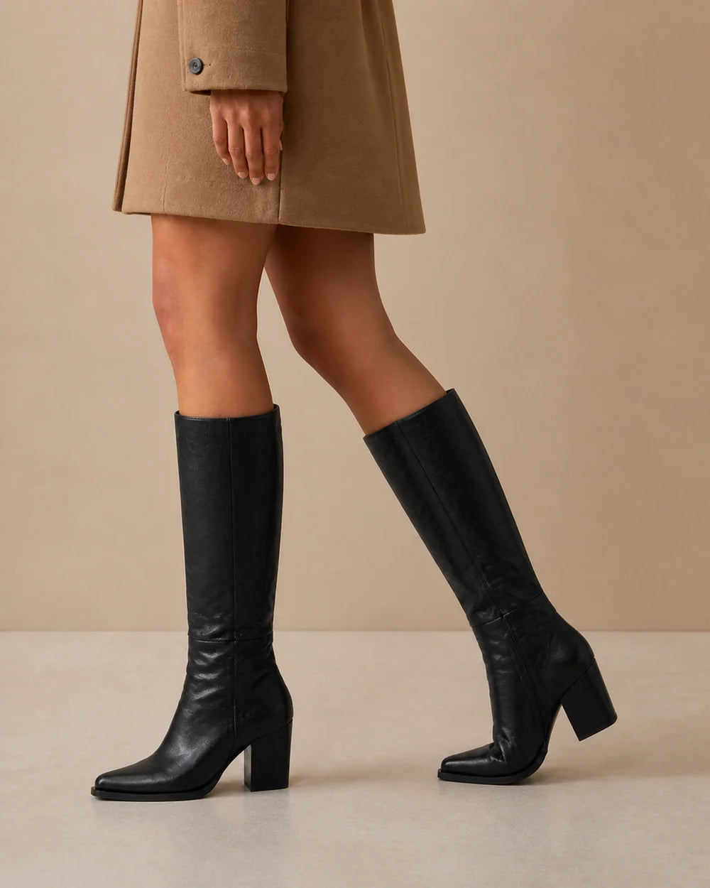Black pointed-toe knee-high boots, movement view