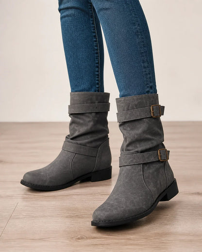 Grey low-heel buckle slouch boots for women, worn close-up