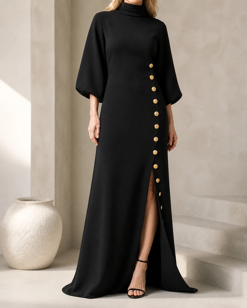 Women’s black maxi dress with gold buttons, front three-quarter view